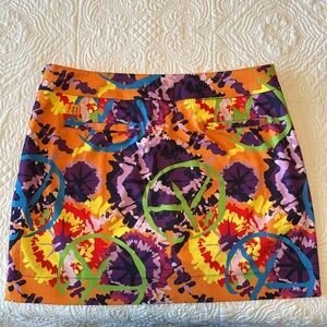 Loudmouth Golf Skort Size 10. Colorful Woodstock Peace Signs pattern.
